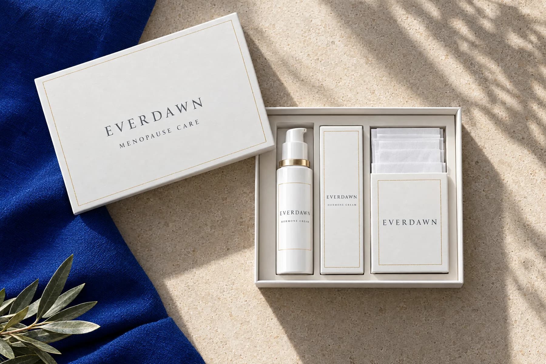 An opened Everdawn menopause care kit with a cream pump, its carton, an instruction leaflet and a care card