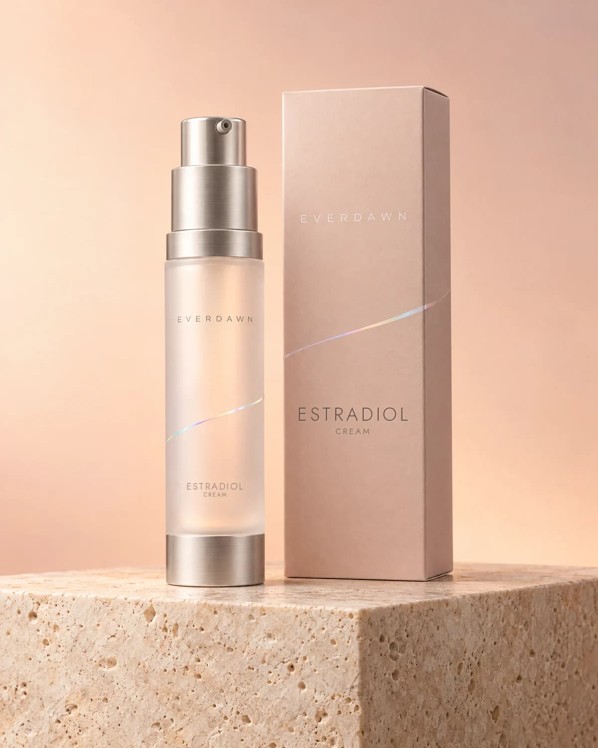 Illustrative packaging: a hormone cream pump beside its carton on a travertine plinth against a soft studio background. Your medicine is labeled and dispensed by the licensed pharmacy.