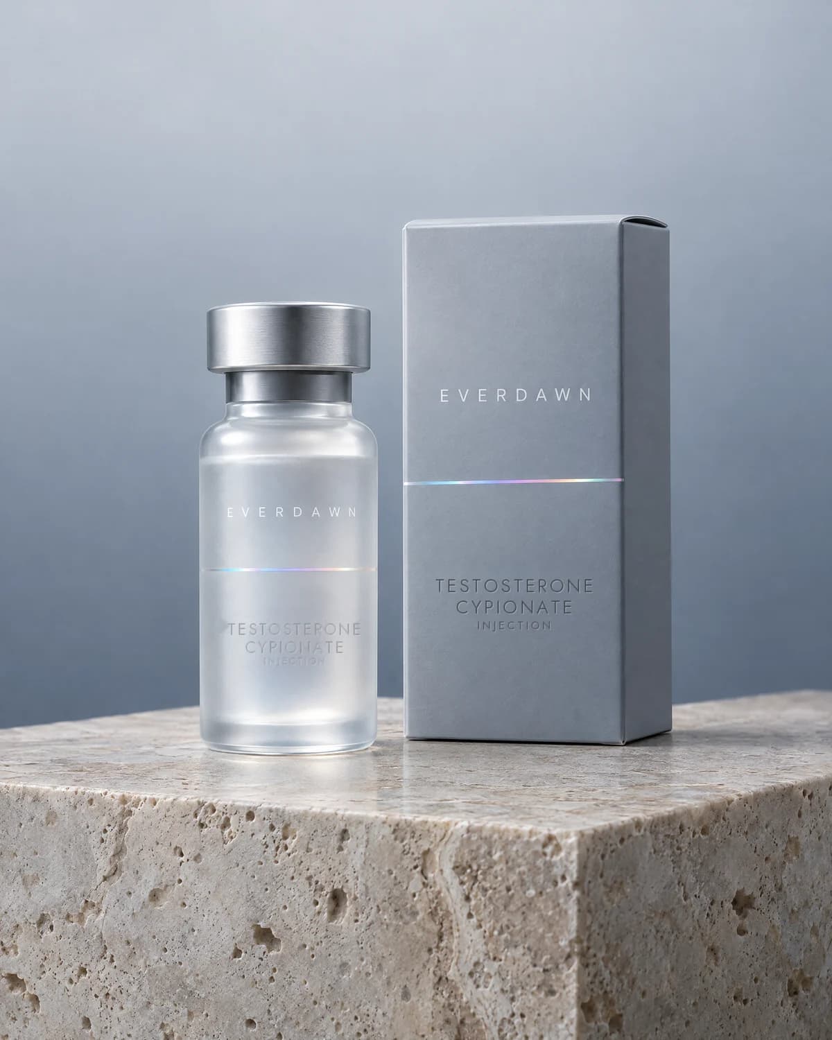 A frosted testosterone cypionate vial beside its carton on a travertine plinth