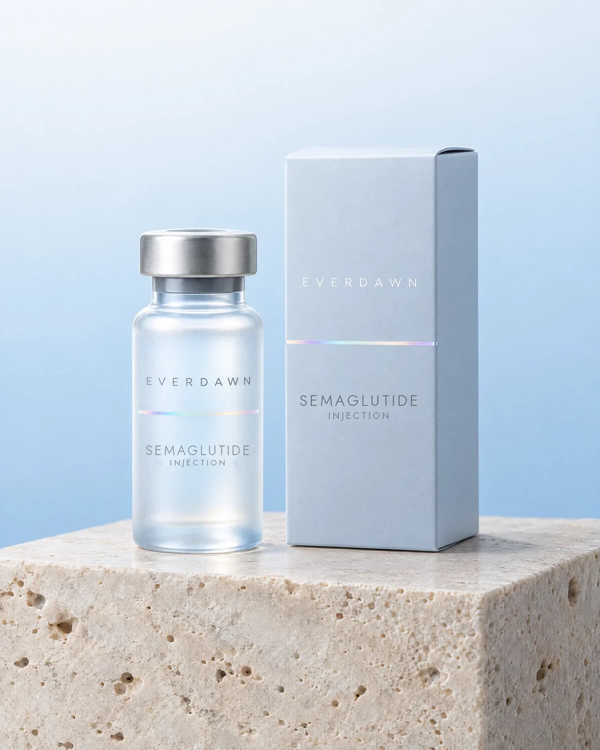 Illustrative packaging: a semaglutide injection vial beside its carton on a travertine plinth against a soft studio background. Your medicine is labeled and dispensed by the licensed pharmacy.